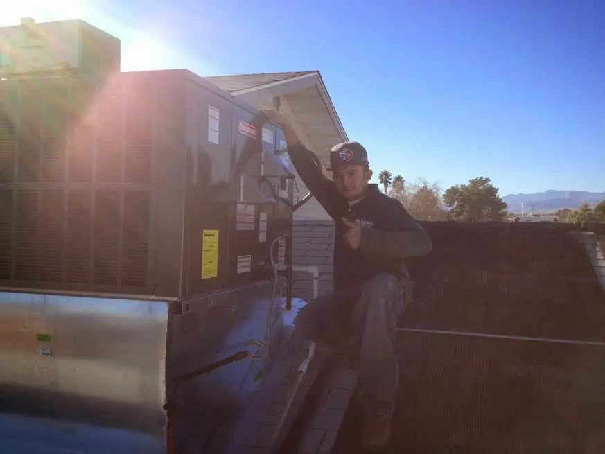 HVAC technician performing HVAC Inspection on a rooftop unit in Mila Doce